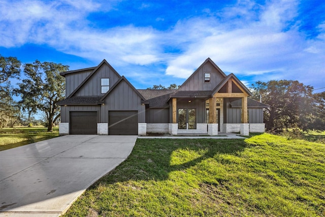 modern inspired farmhouse with concrete driveway, stone siding, roof with shingles, board and batten siding, and a front yard