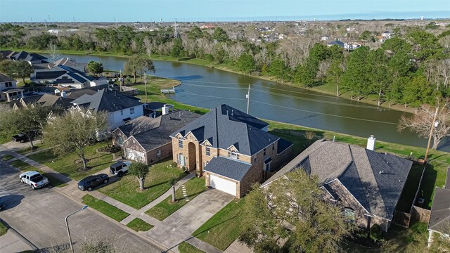 birds eye view of property featuring a water view and a residential view