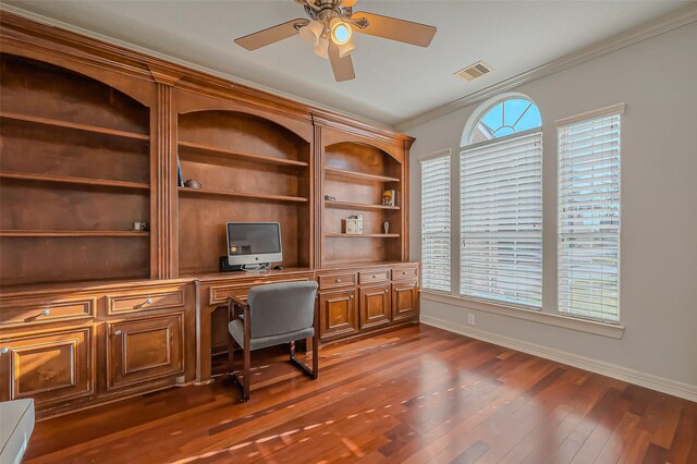 office space featuring a healthy amount of sunlight, visible vents, dark wood-type flooring, and ornamental molding