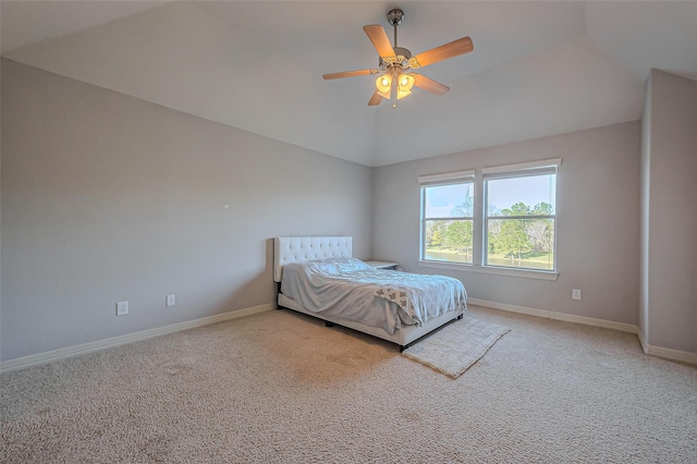 unfurnished bedroom featuring lofted ceiling, carpet, baseboards, and a ceiling fan