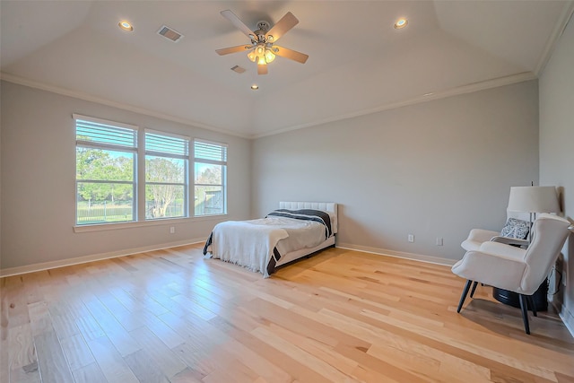 bedroom with crown molding, light wood-type flooring, visible vents, and baseboards