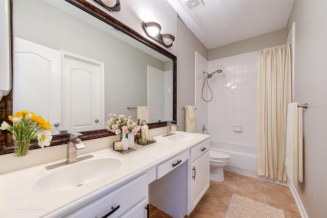 bathroom with tile patterned flooring, visible vents, a sink, and double vanity