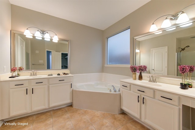 bathroom with tile patterned flooring, two vanities, a sink, and a bath