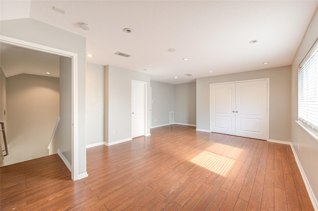 spare room with baseboards, visible vents, wood finished floors, and recessed lighting