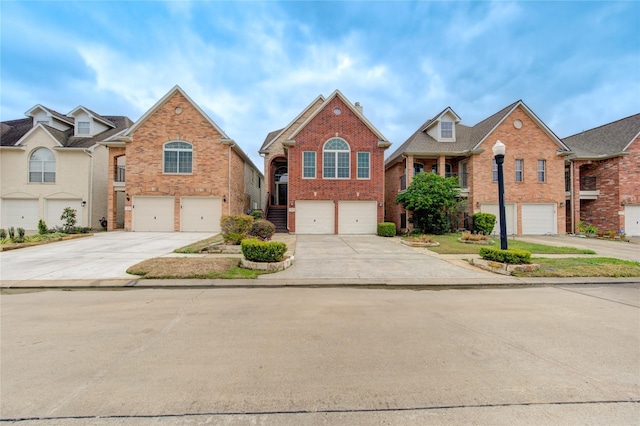 traditional home with driveway, an attached garage, and brick siding