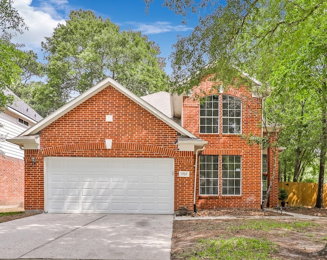 traditional-style home with brick siding, concrete driveway, a garage, and fence