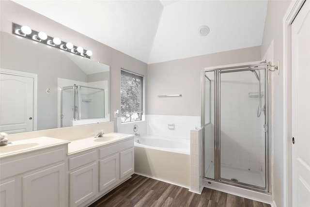 full bathroom with wood finished floors, lofted ceiling, a stall shower, a sink, and a bath