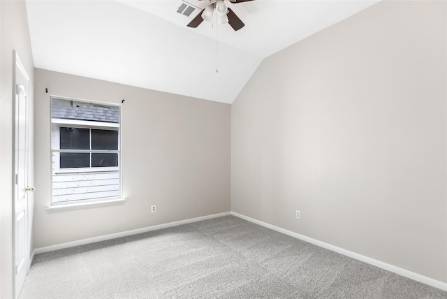 spare room with baseboards, visible vents, lofted ceiling, ceiling fan, and carpet flooring