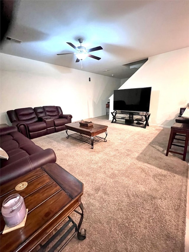 living room featuring carpet flooring, visible vents, and ceiling fan