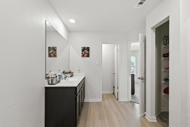 22052 Angelico Dr, Magnolia, TX 77355 - bathroom with wood finished floors and double vanity