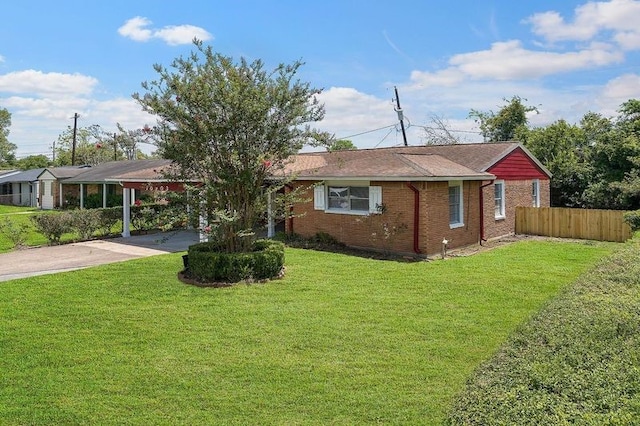 ranch-style home with a front yard, brick siding, driveway, and fence