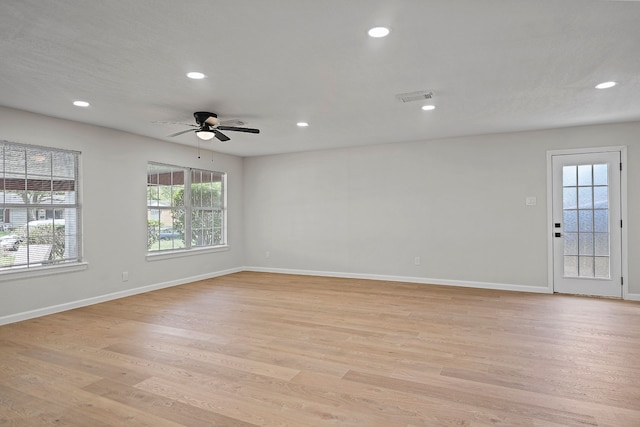 unfurnished room featuring recessed lighting, visible vents, light wood-style flooring, and baseboards