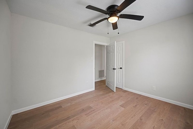 unfurnished bedroom with baseboards, visible vents, ceiling fan, and light wood finished floors