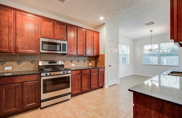 kitchen featuring tasteful backsplash, visible vents, dark stone counters, appliances with stainless steel finishes, and light tile patterned flooring