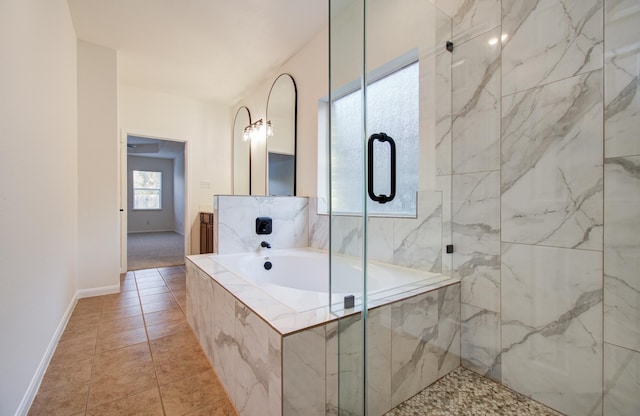 bathroom with a marble finish shower, tile patterned flooring, baseboards, and a garden tub