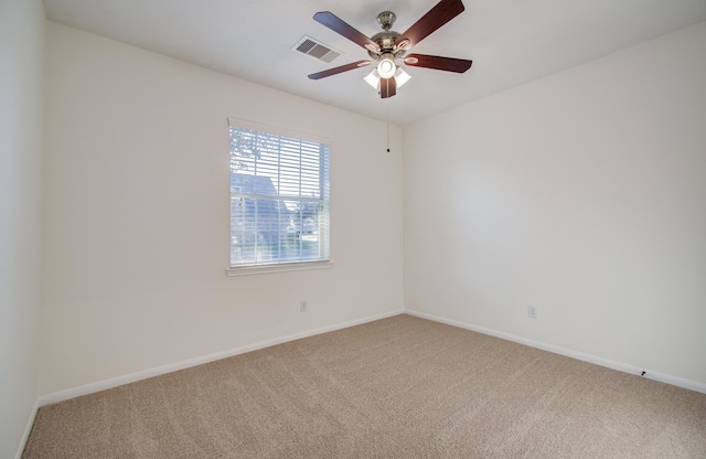 carpeted empty room featuring visible vents, baseboards, and a ceiling fan