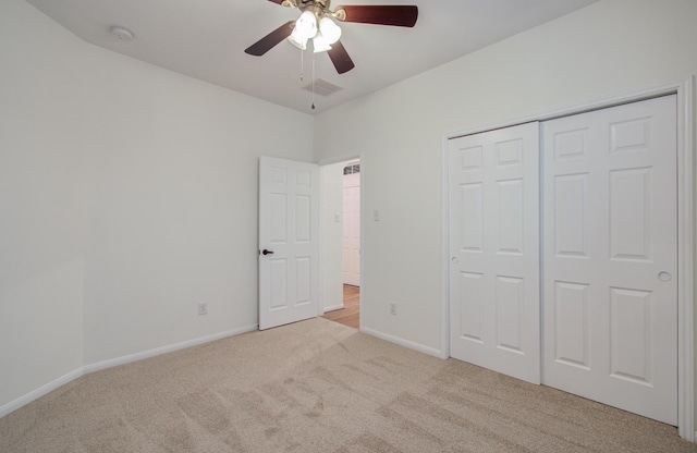 unfurnished bedroom featuring visible vents, baseboards, carpet, a closet, and a ceiling fan