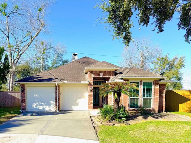 view of front of home featuring driveway, a chimney, an attached garage, fence, and brick siding