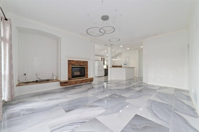 unfurnished living room featuring marble finish floor, recessed lighting, crown molding, and a glass covered fireplace