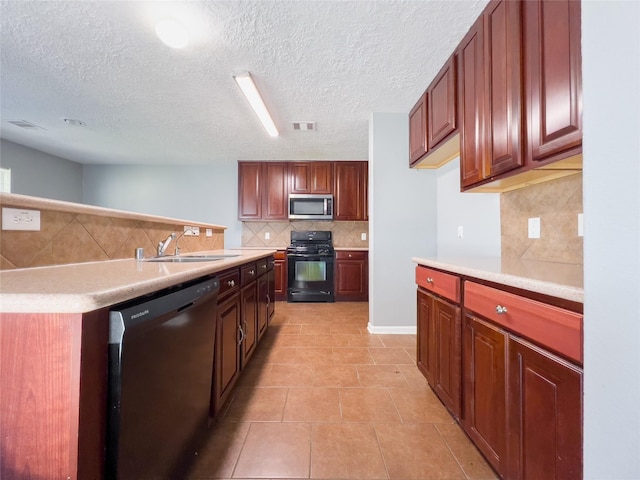 kitchen featuring light countertops, appliances with stainless steel finishes, a sink, and tasteful backsplash