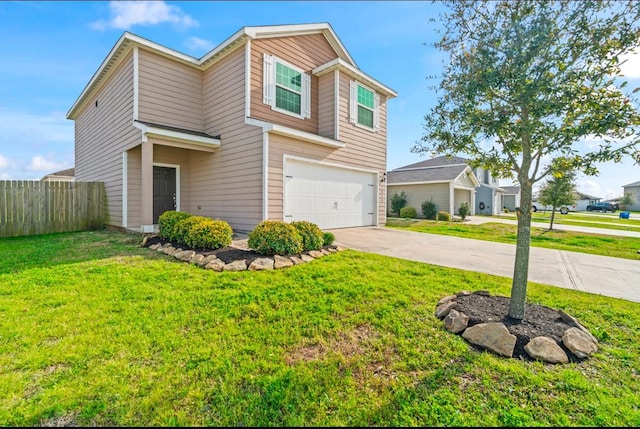 traditional-style house featuring a front yard, fence, driveway, and an attached garage