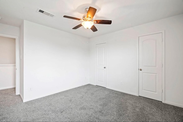 unfurnished bedroom featuring a ceiling fan, carpet, visible vents, and baseboards