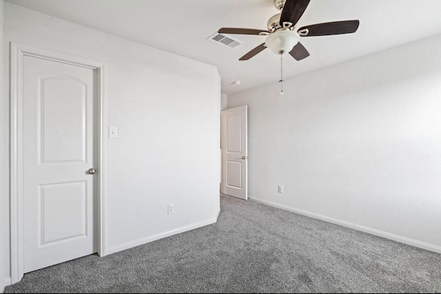 spare room with ceiling fan, carpet, visible vents, and baseboards