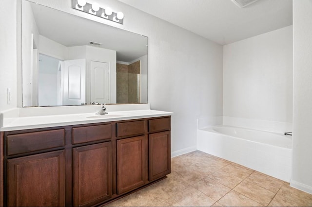 full bath featuring visible vents, a garden tub, vanity, and tile patterned floors