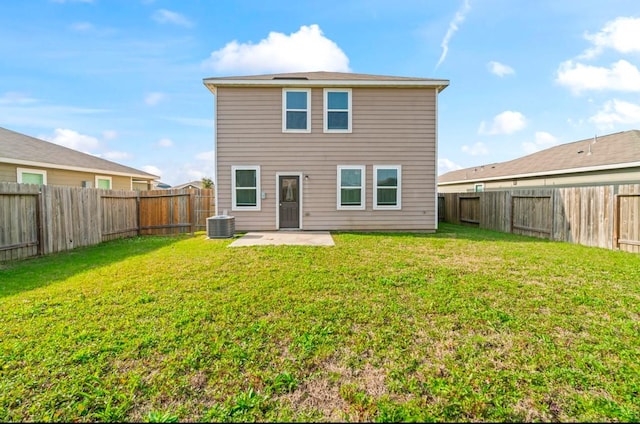 rear view of property featuring a yard, a patio area, a fenced backyard, and central air condition unit