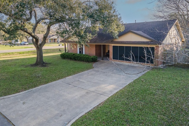 view of front of home with an attached garage, brick siding, driveway, roof with shingles, and a front yard