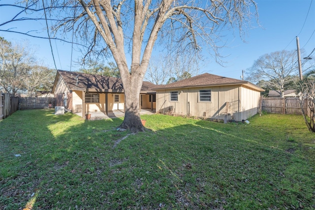 back of house with a patio area, a fenced backyard, and a yard