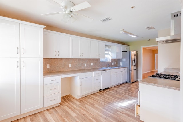 kitchen featuring white dishwasher, light wood-style flooring, stainless steel fridge with ice dispenser, wall chimney exhaust hood, and tasteful backsplash