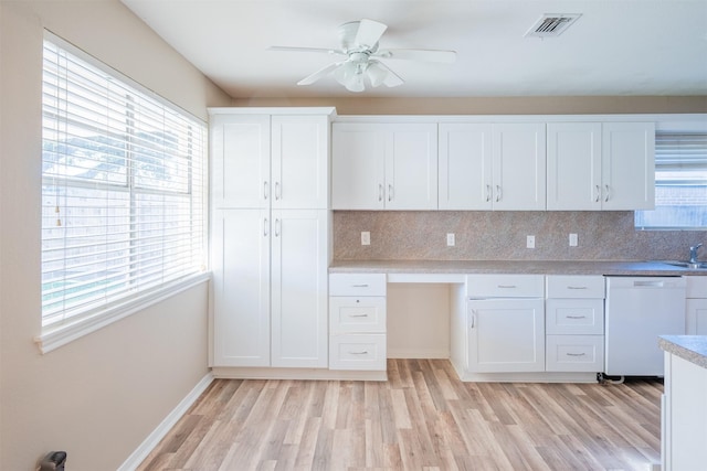 kitchen with dishwasher, a wealth of natural light, visible vents, and white cabinetry