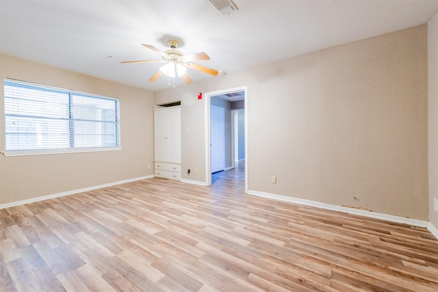 unfurnished bedroom featuring light wood-style flooring, visible vents, ceiling fan, and baseboards