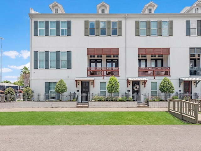 view of property featuring a fenced front yard and stucco siding