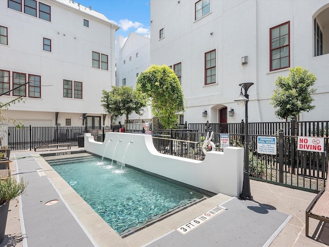 view of swimming pool with fence