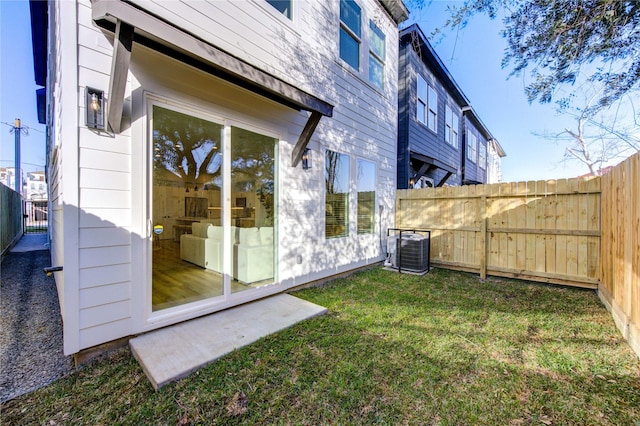 view of yard featuring a fenced backyard and central AC