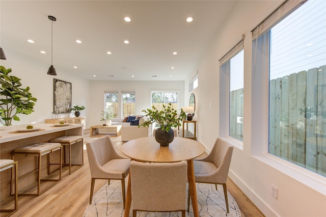 dining space featuring recessed lighting, baseboards, and light wood finished floors