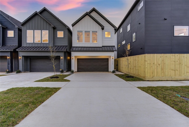 view of front facade featuring board and batten siding, a standing seam roof, and an attached garage