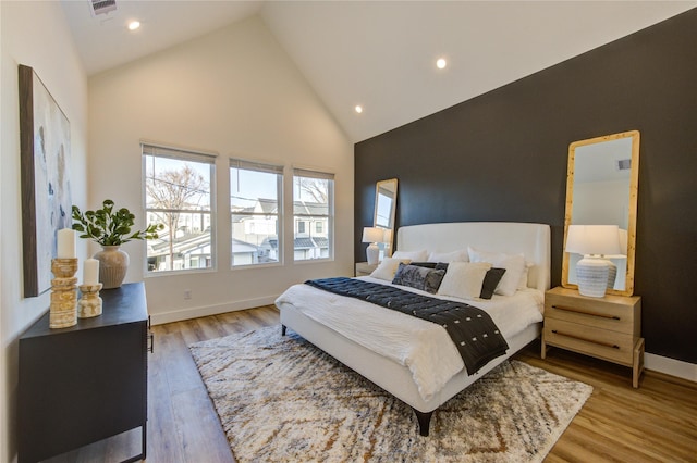 bedroom featuring high vaulted ceiling, recessed lighting, visible vents, baseboards, and light wood-type flooring