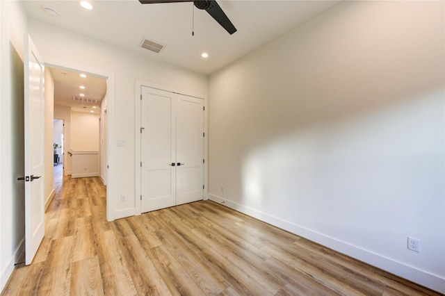 unfurnished bedroom with light wood-type flooring, baseboards, and recessed lighting