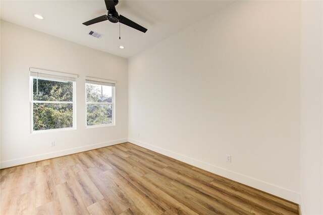 unfurnished room with recessed lighting, a ceiling fan, visible vents, baseboards, and light wood-type flooring