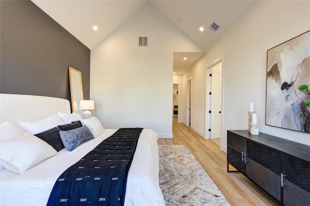 bedroom featuring high vaulted ceiling, visible vents, wood finished floors, and recessed lighting