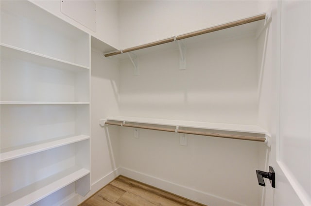 spacious closet featuring light wood-style flooring