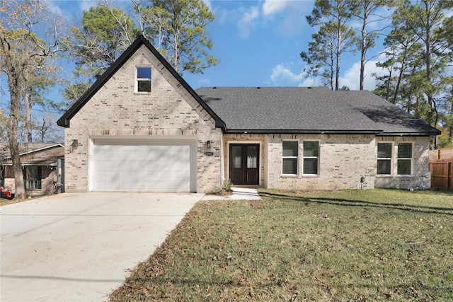 view of front of house with driveway, brick siding, and a front yard