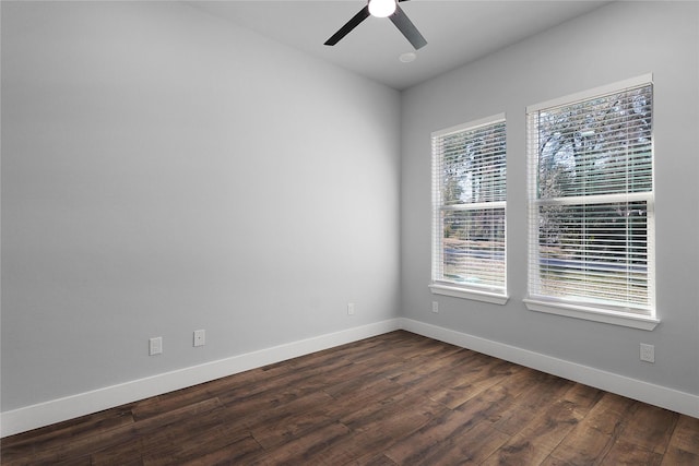 spare room with dark wood-style floors, ceiling fan, and baseboards