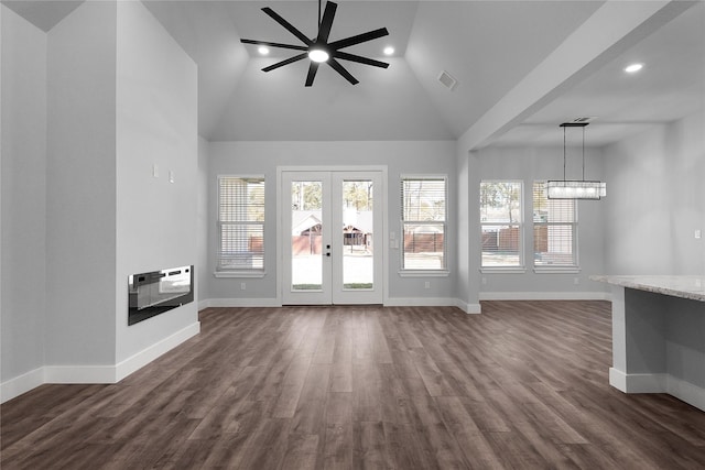 unfurnished living room featuring baseboards, visible vents, dark wood-style floors, heating unit, and french doors