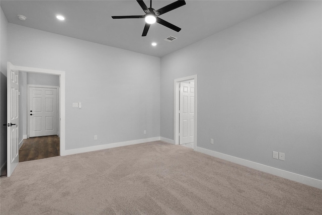 spare room with carpet, visible vents, baseboards, and recessed lighting