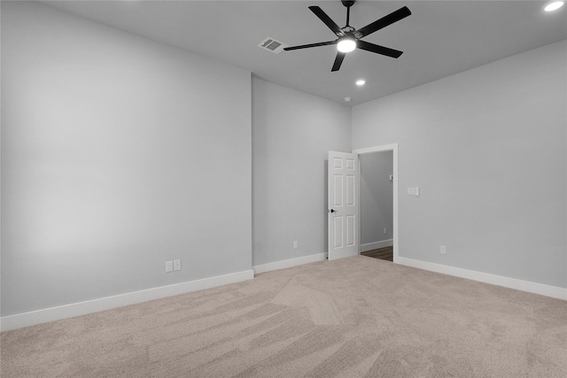 spare room featuring carpet, visible vents, baseboards, and recessed lighting