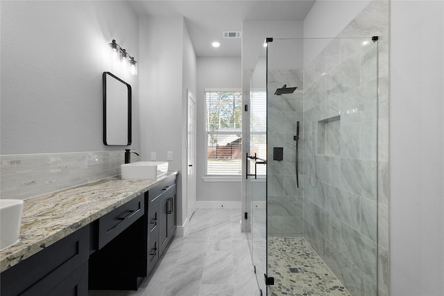 full bathroom featuring vanity, visible vents, baseboards, marble finish floor, and a shower stall